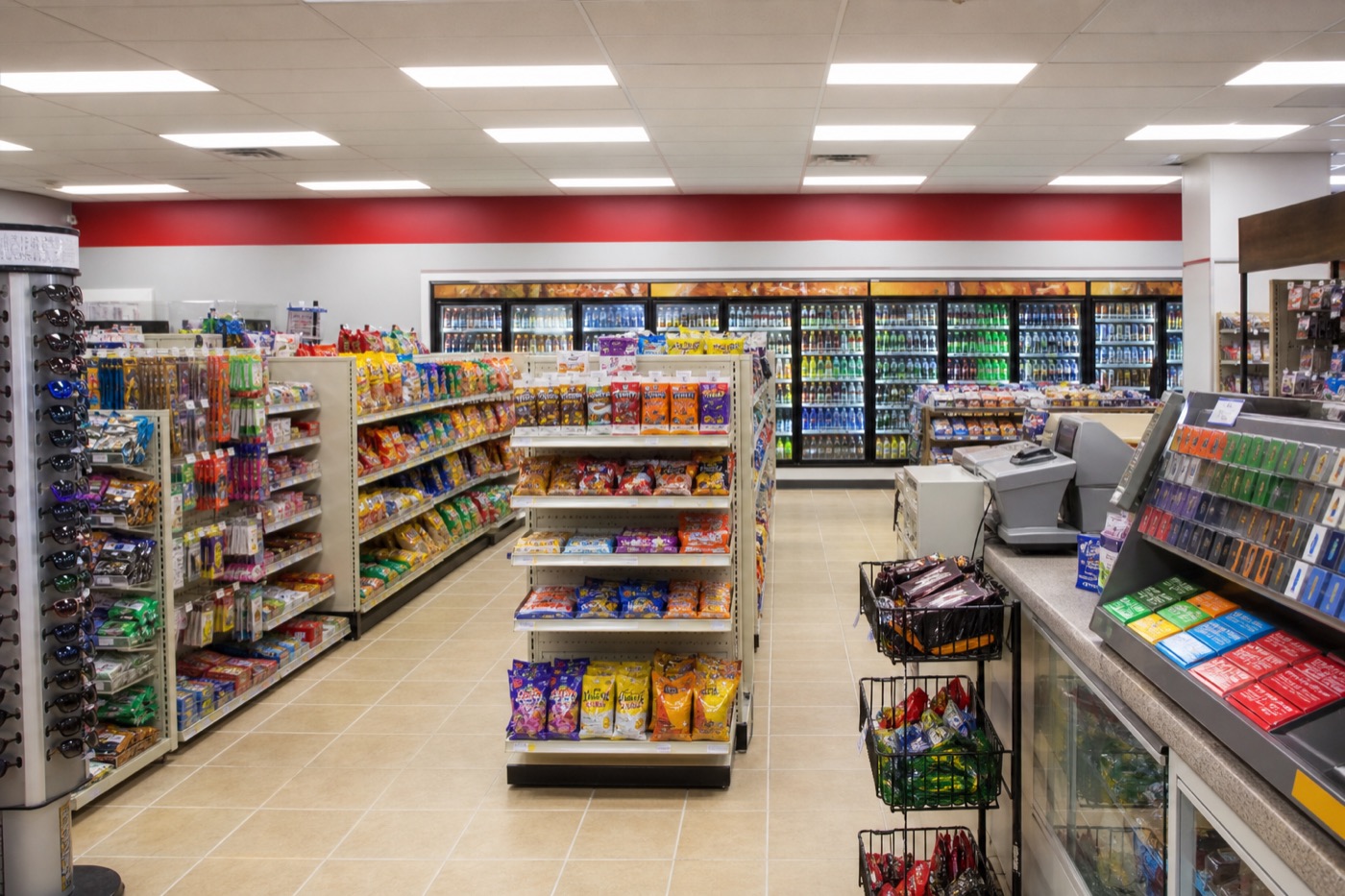 Bright, well-stocked convenience store aisle with organized shelving